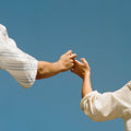 Hands Holding against the sky backdrop