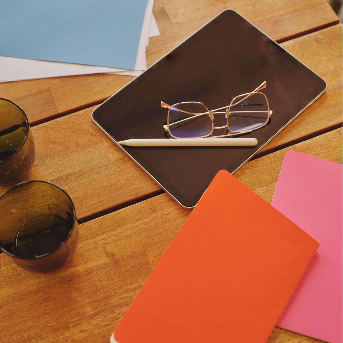 ipad classes and notebooks on a desk